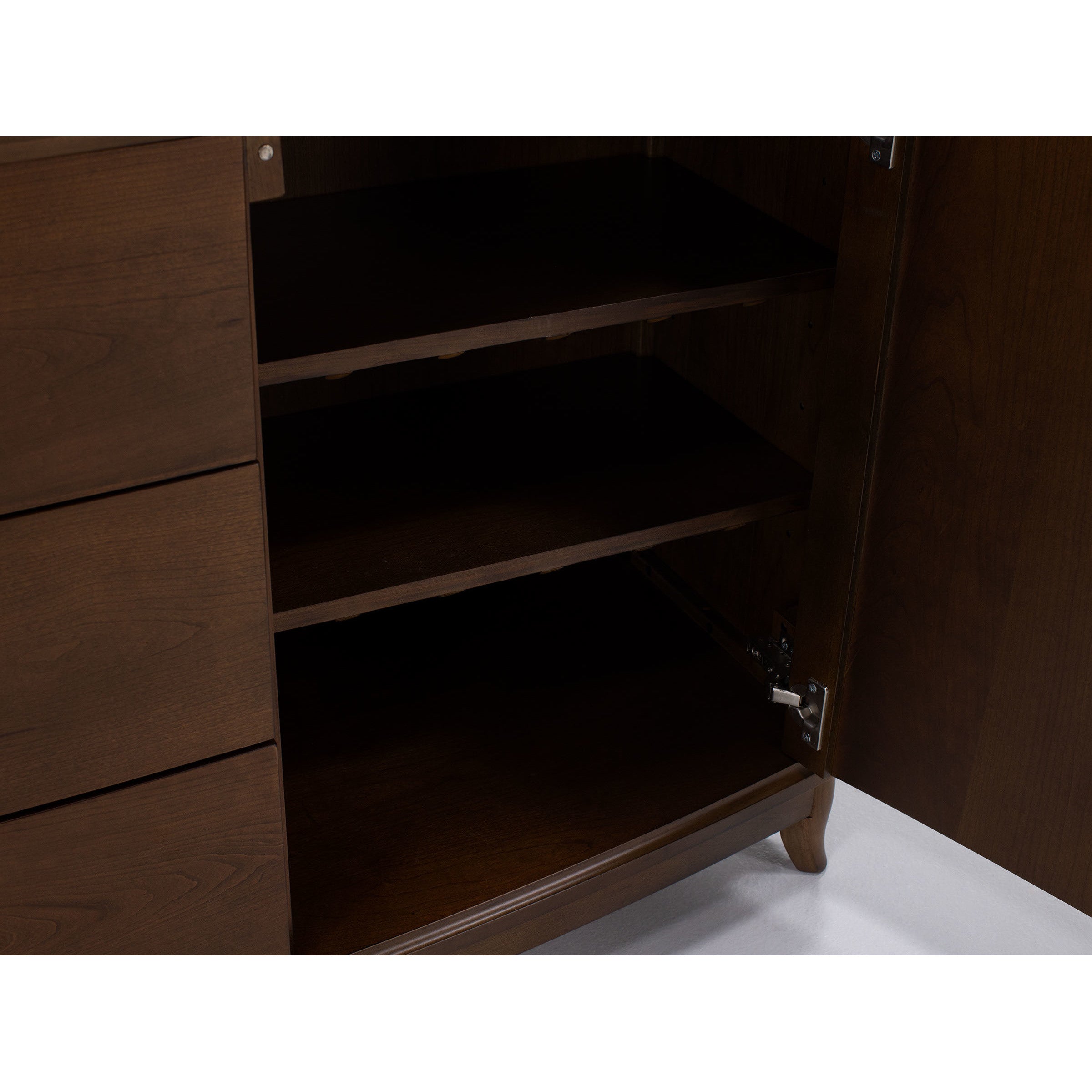 Open cabinet with wooden shelves and partially visible drawers.