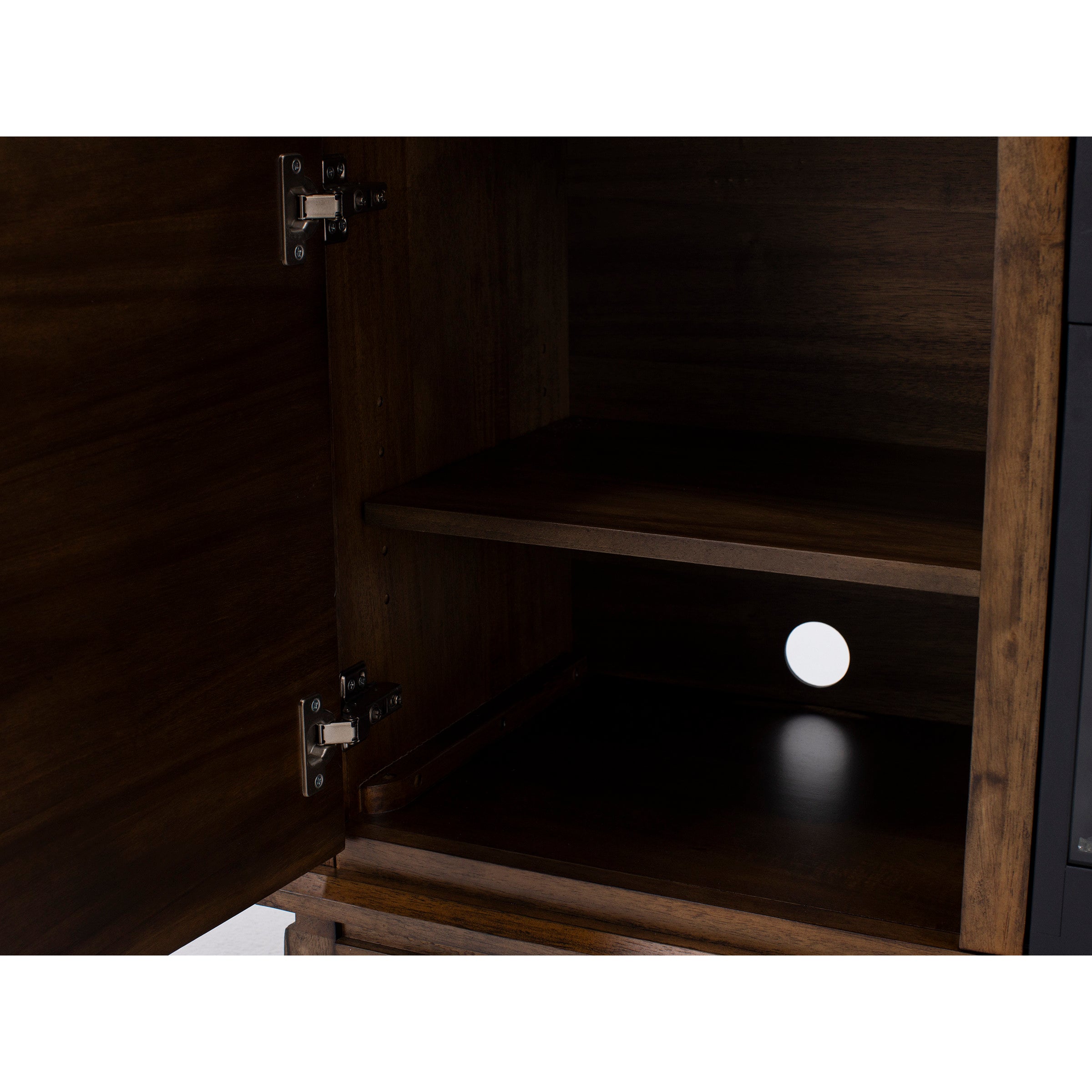 Interior of a wooden cabinet with an open door and one shelf, showing a cord hole in the back.