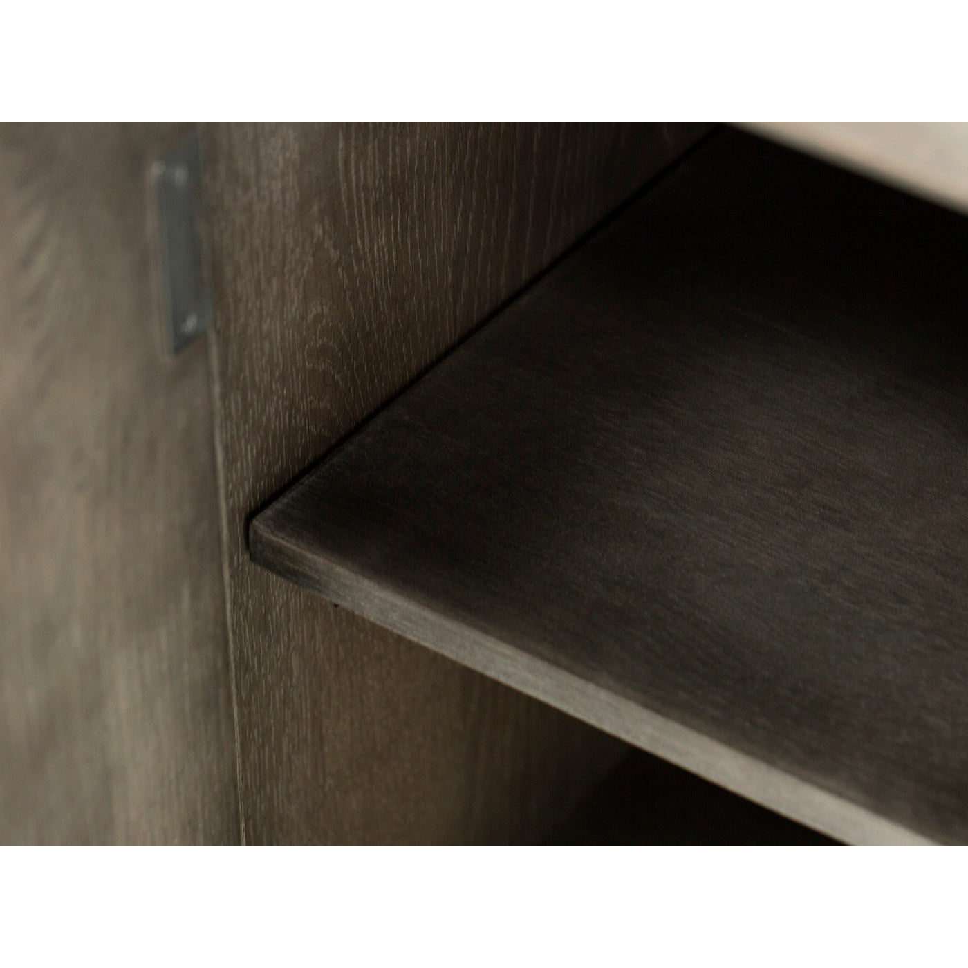 Close-up of a wood shelf inside a cabinet.