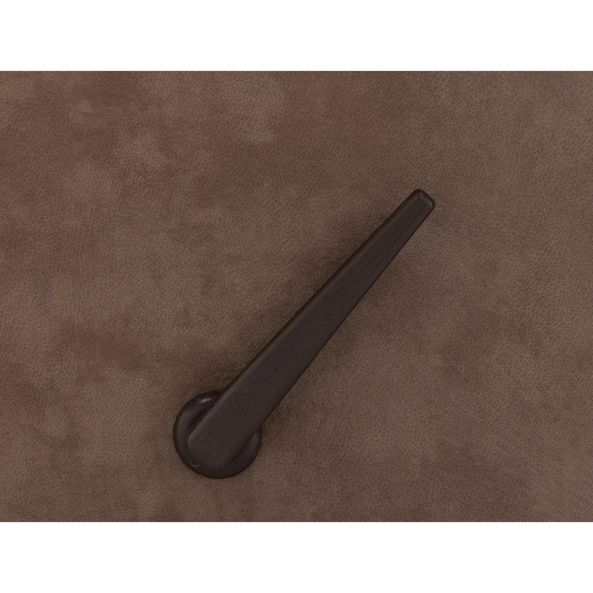 Close-up of a dark brown lever handle on a textured brown surface.