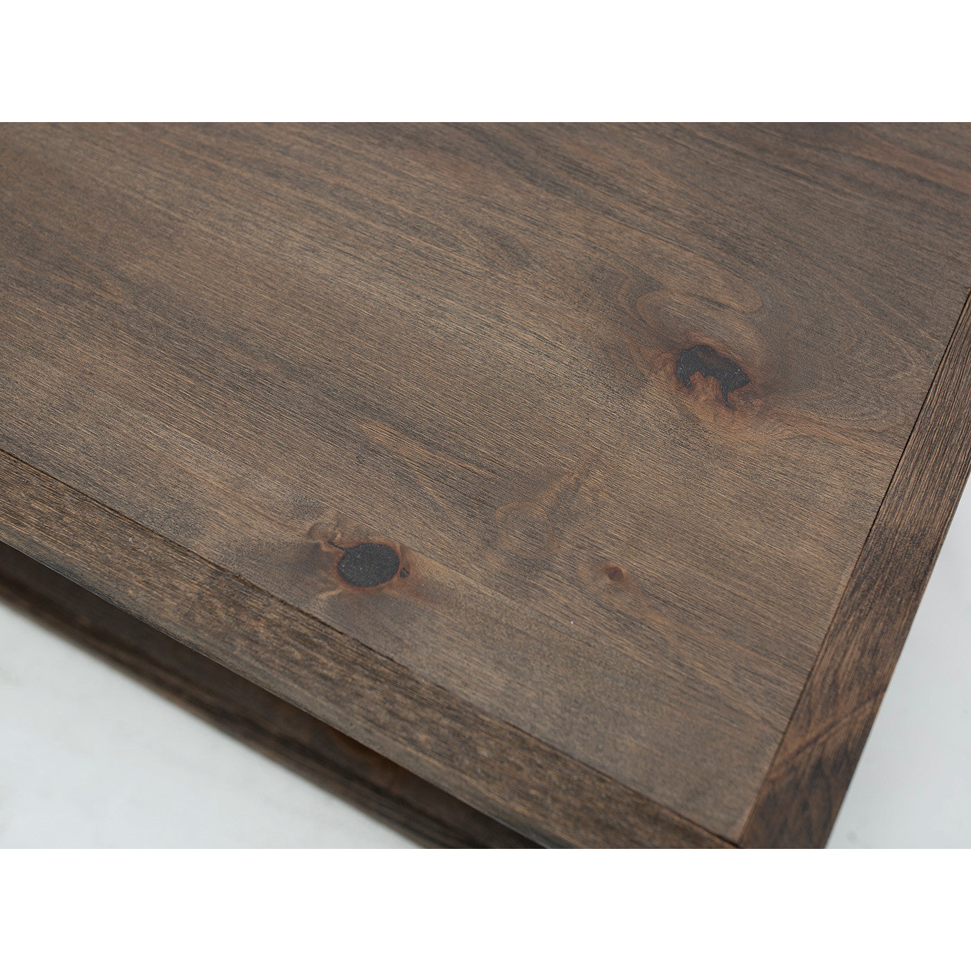Close-up of a wooden surface with visible grain and knots.