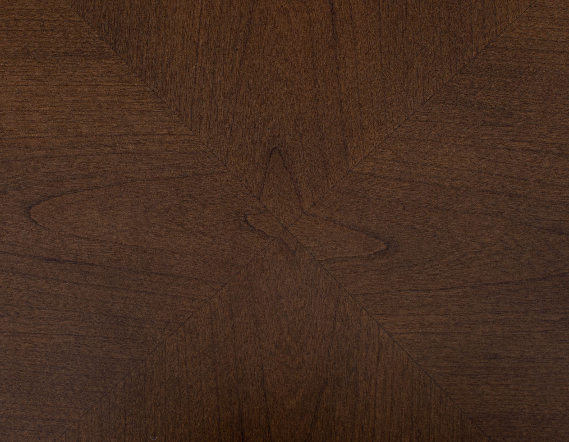 Dark brown wood surface with geometric grain pattern.