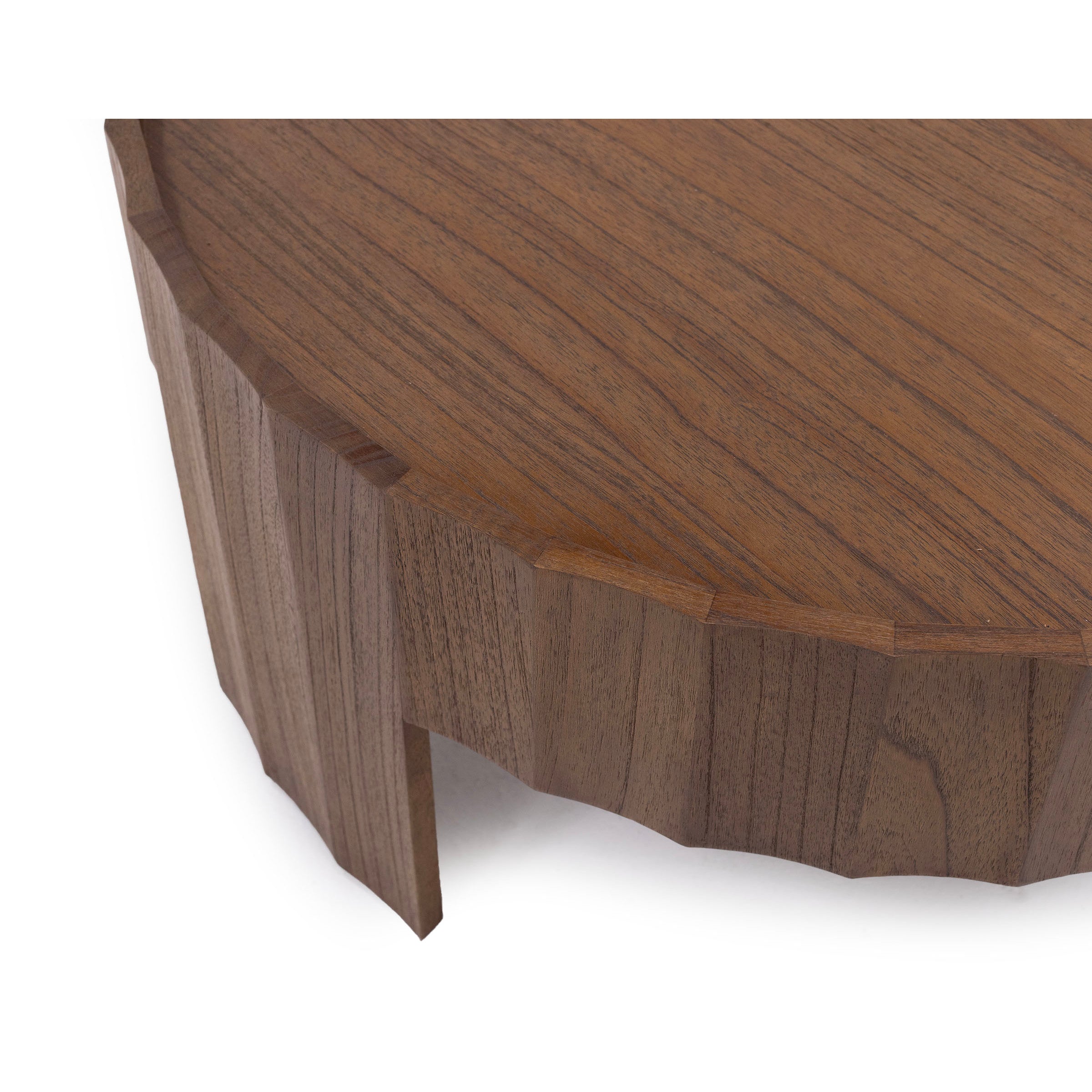 Close-up of a wooden coffee table with a faceted edge design.