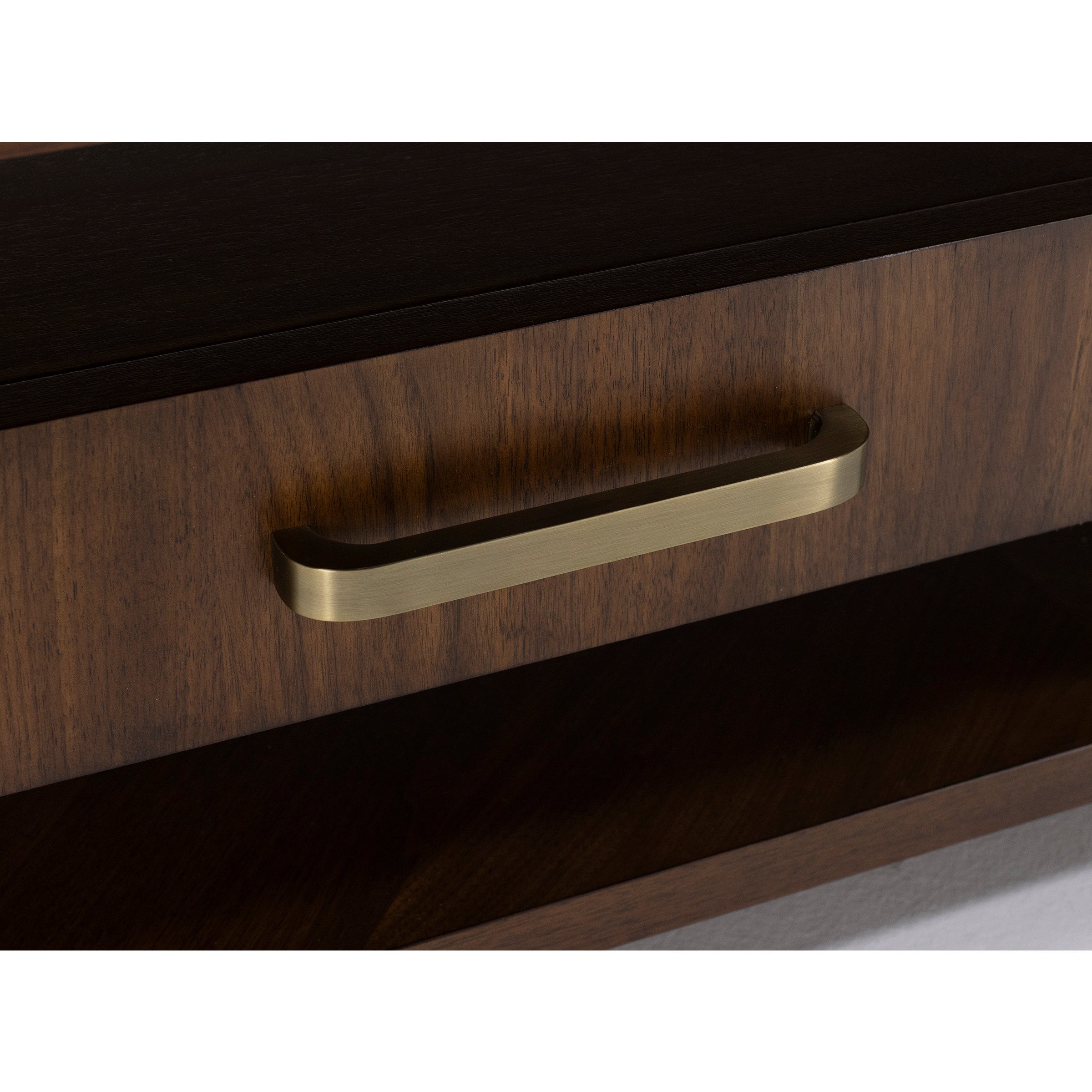 Close-up of a wooden drawer with a brass handle.