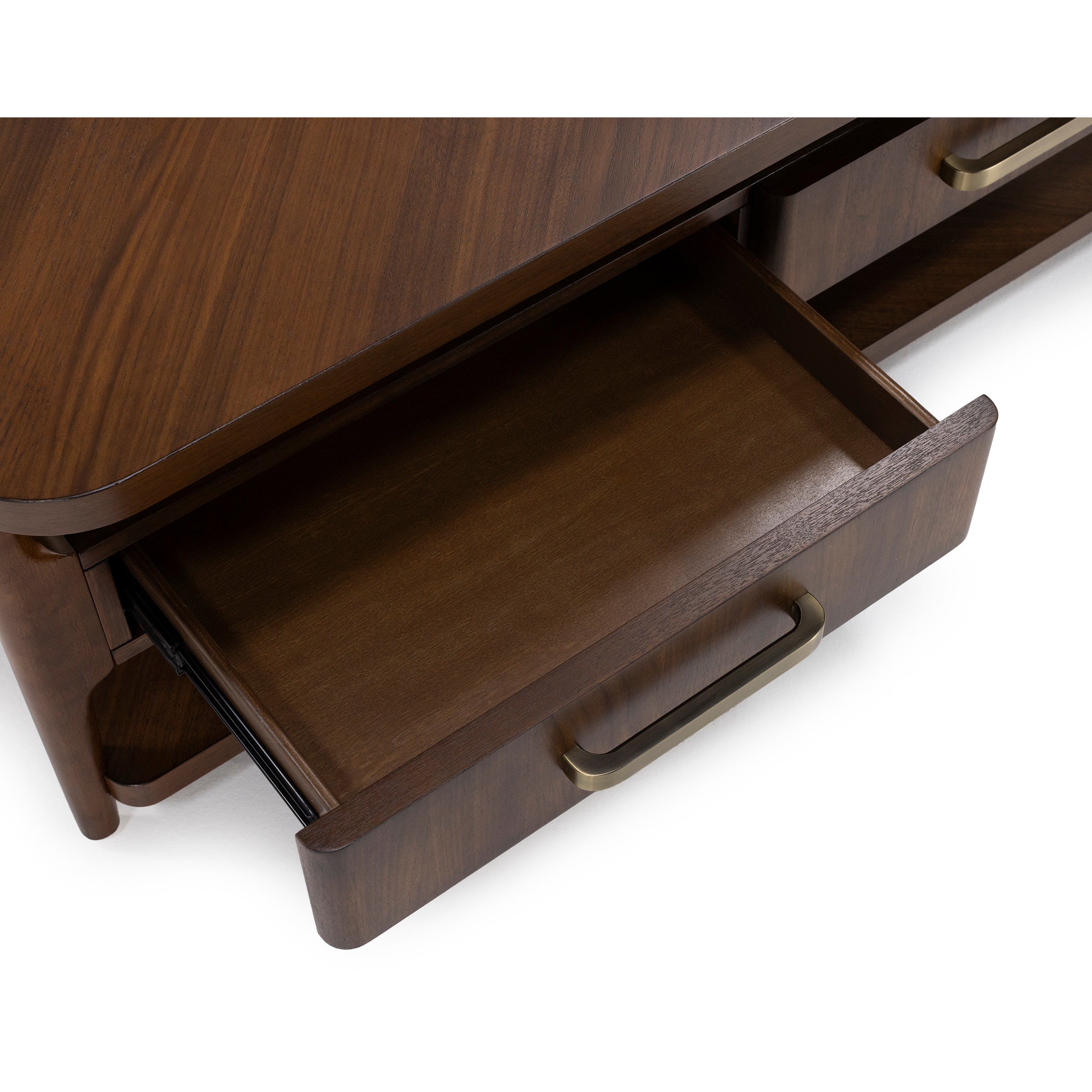 Open wood drawer with brass handle on a brown table.