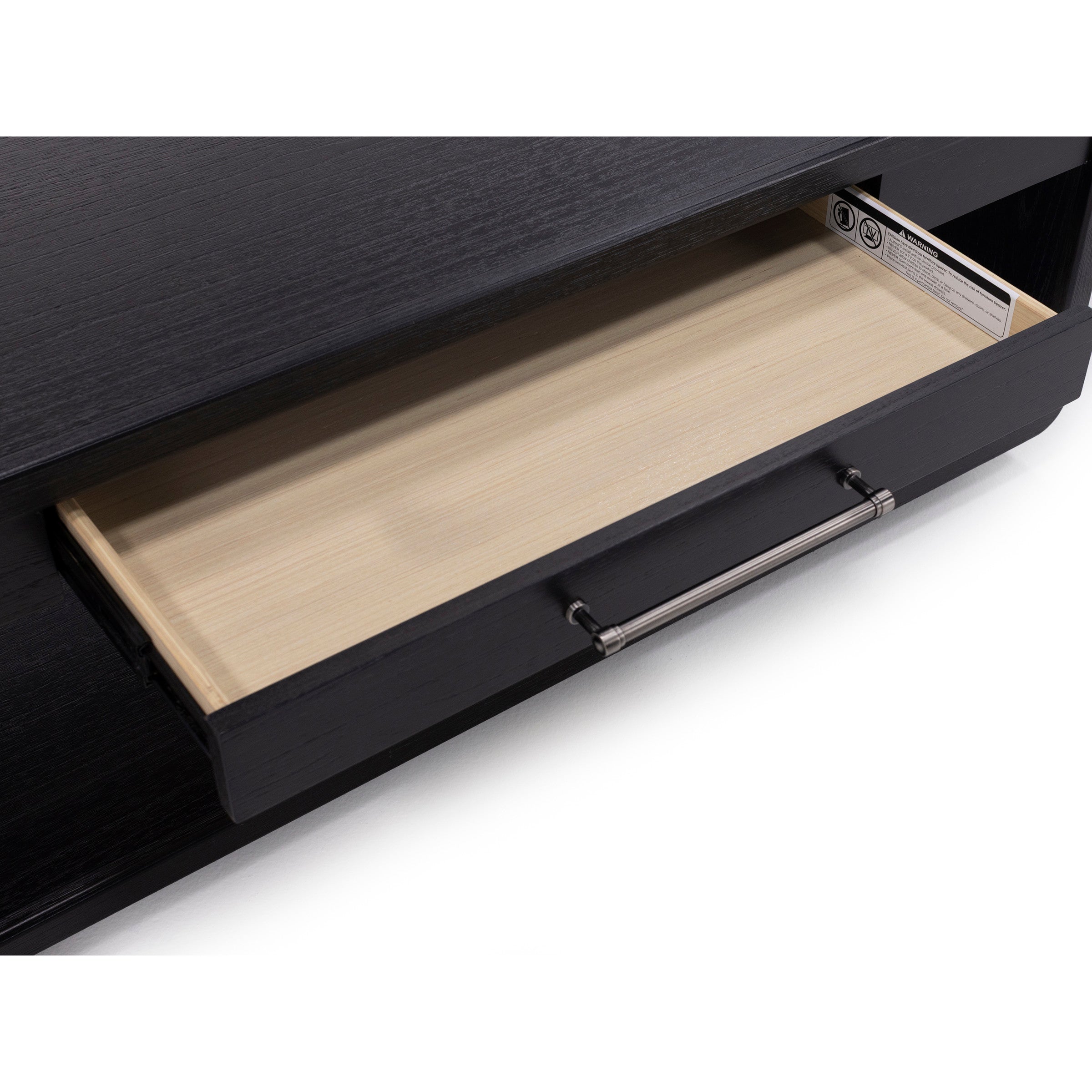 Open black wood drawer with metal handle, showing empty light wood interior.