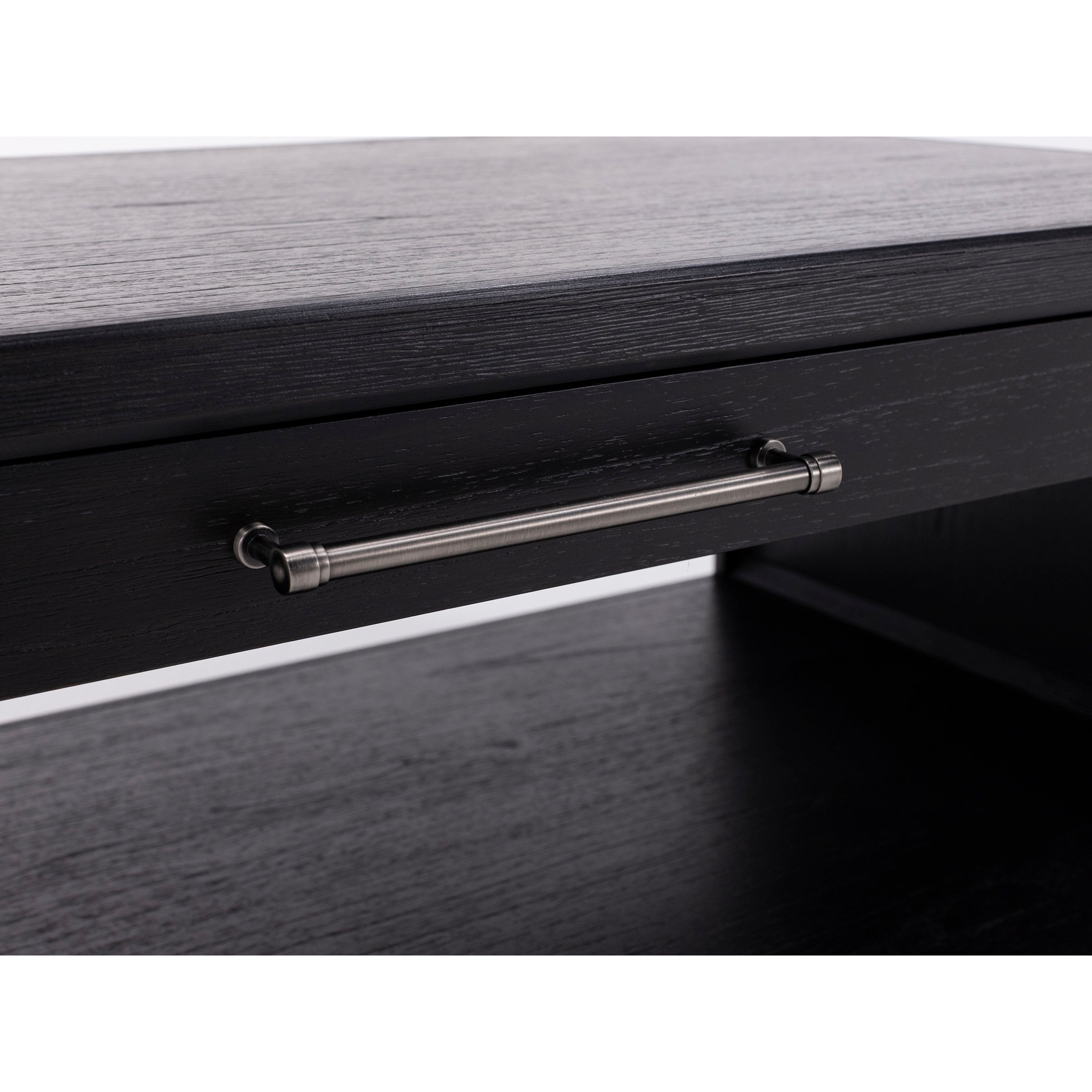 Close-up of a black wooden drawer with a silver metal handle.