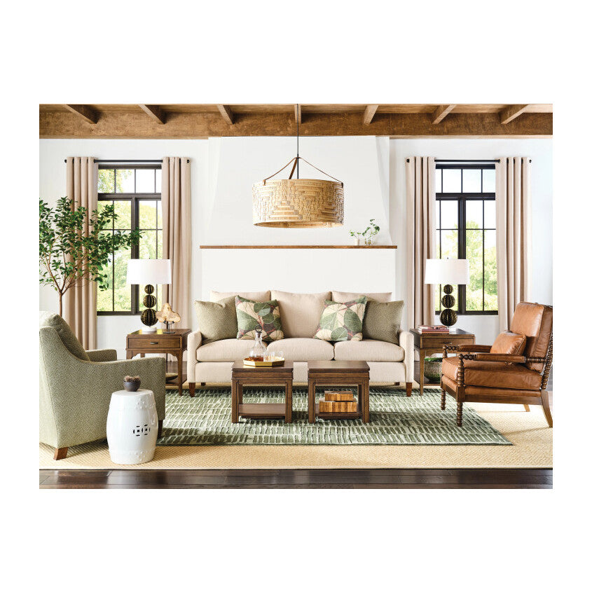 Neutral living room with beige sofa, accent chairs, coffee tables, and modern decor.