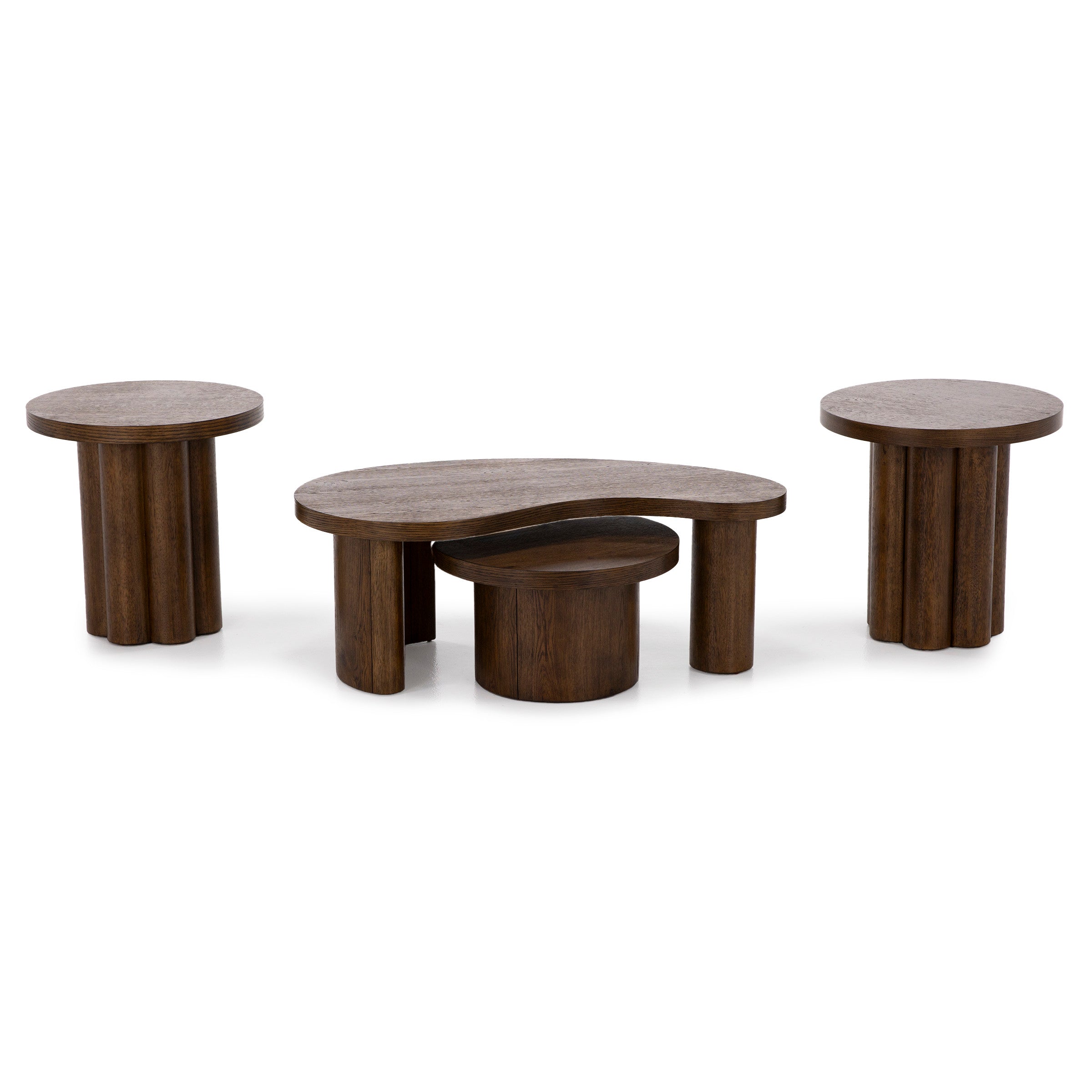 Three modern brown wood tables with round and organic tops and cylindrical legs.