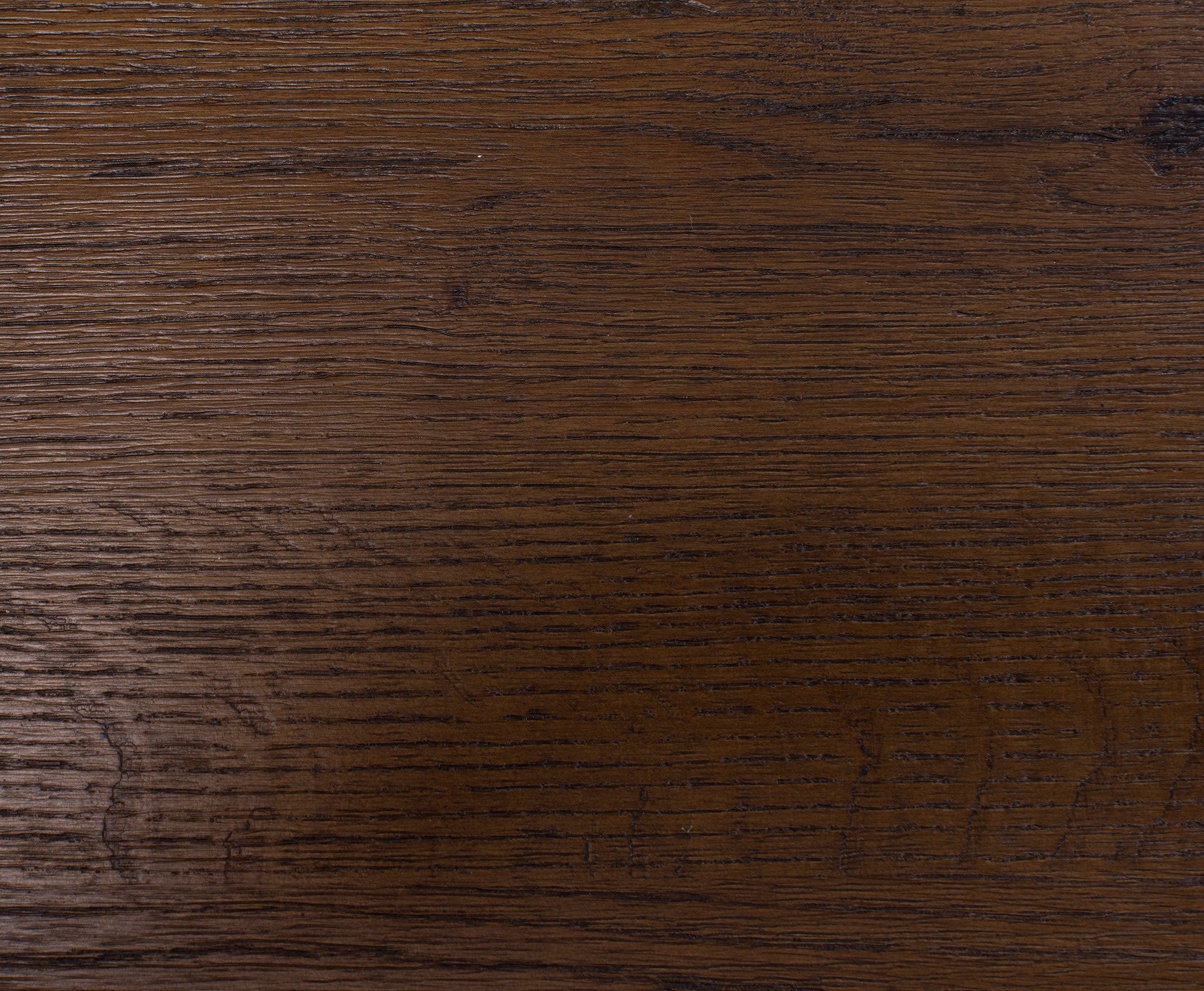 Dark brown wood surface with visible grain texture.
