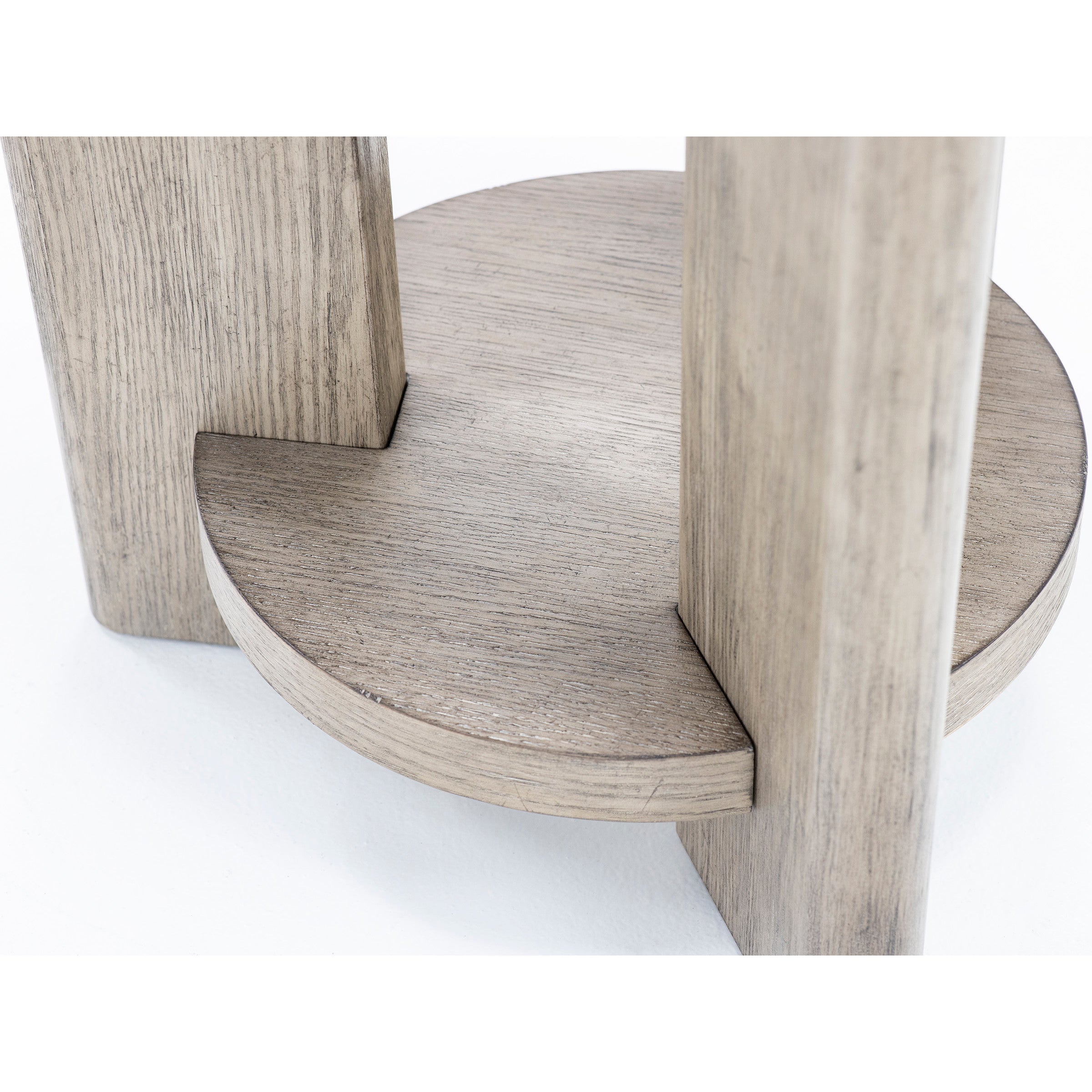 Close-up of a light wood table leg and shelf with a natural finish.