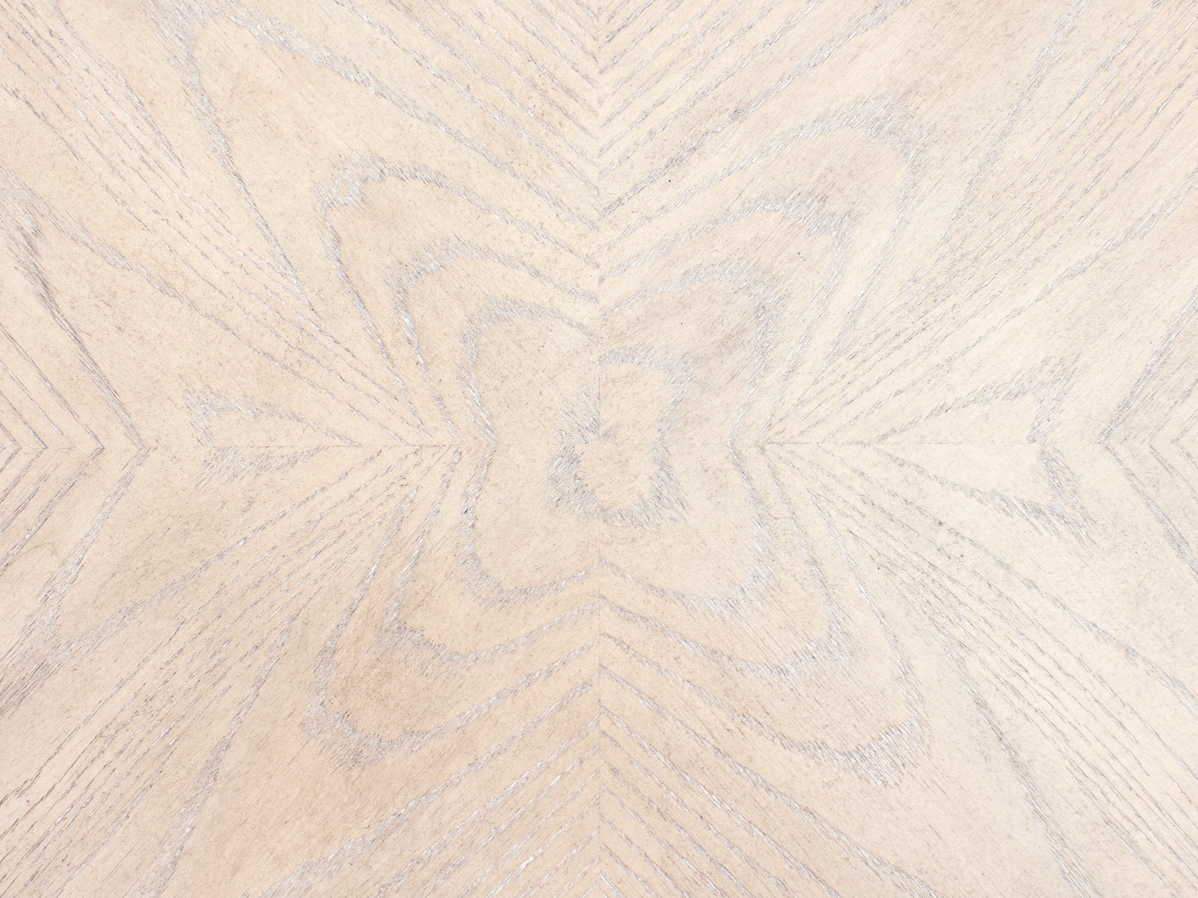 Light wood with a natural grain pattern in a symmetrical, geometric design.