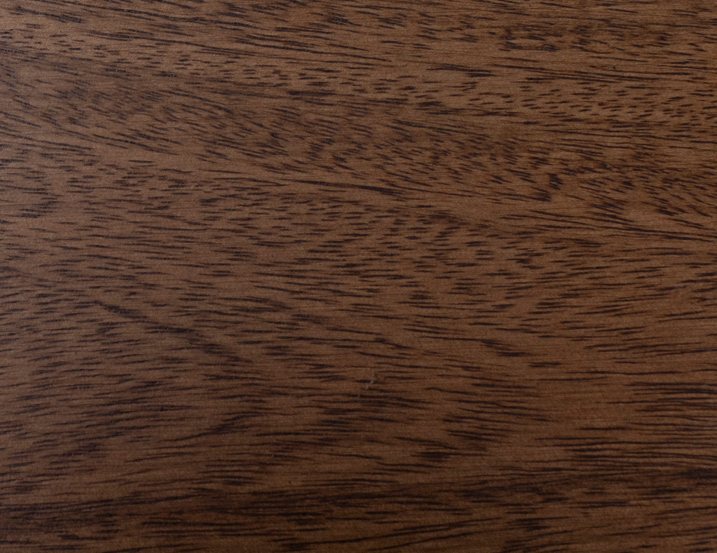Close-up of walnut wood grain with medium brown color and natural texture.