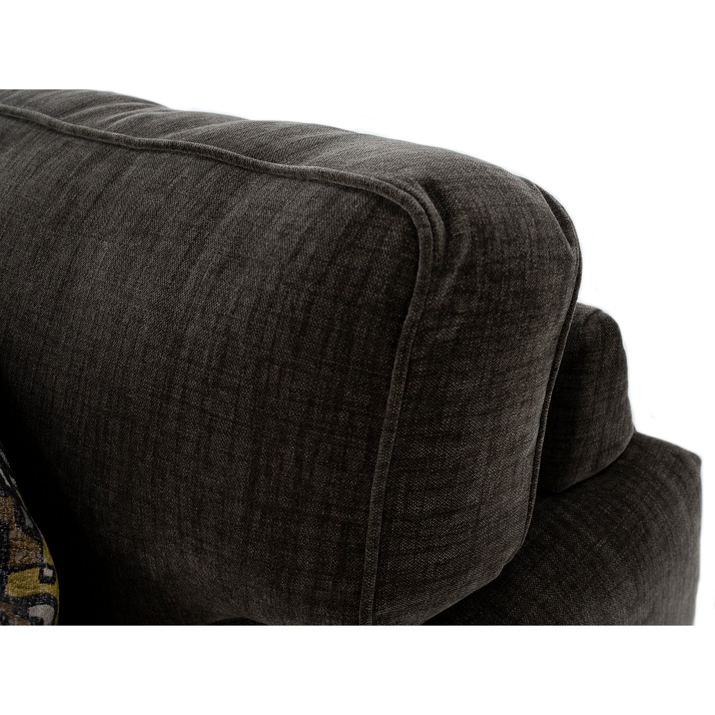 Close-up of a dark fabric sofa arm and cushion.