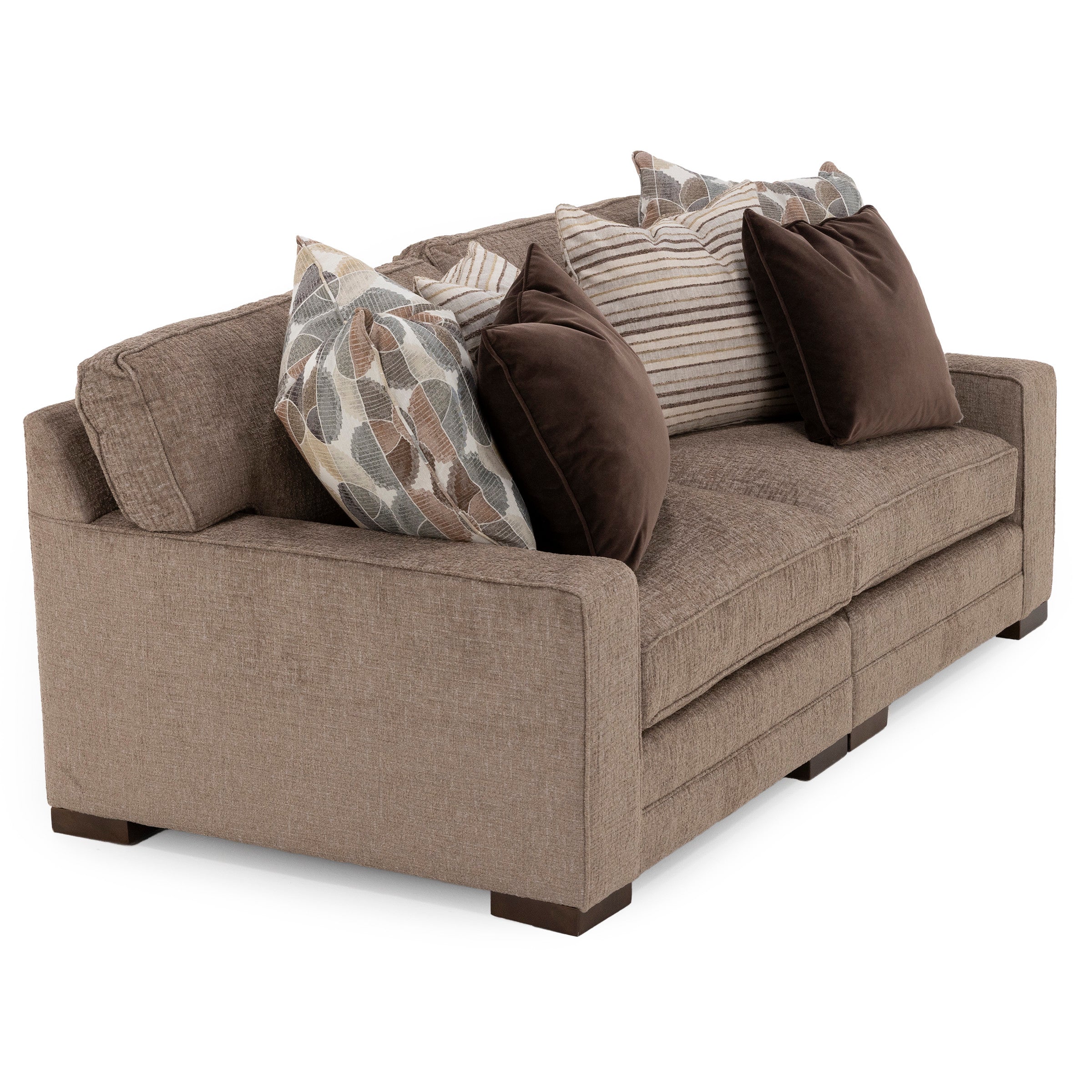Three-seat brown sofa with assorted pillows, angled view.