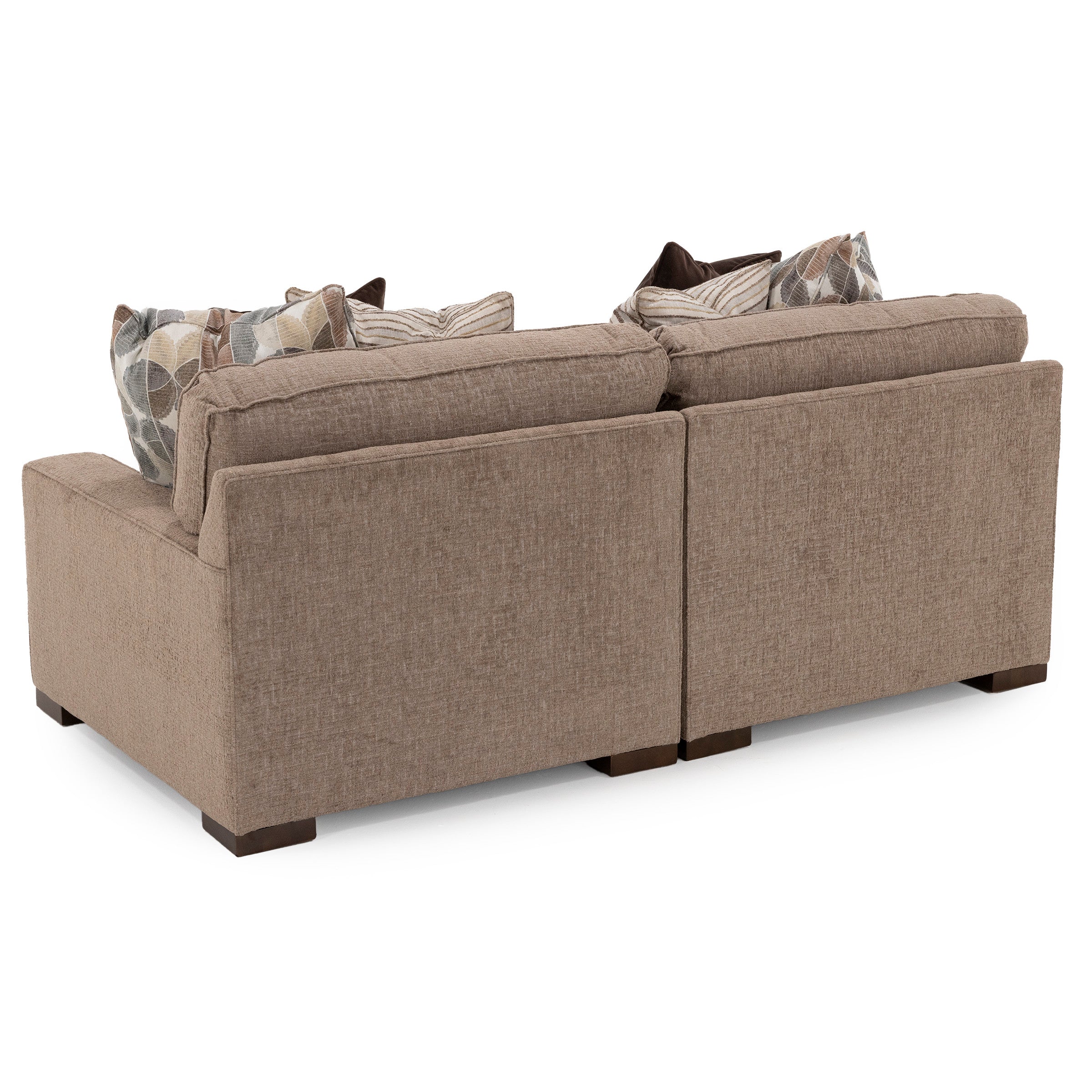 Back view of a brown sectional sofa with patterned pillows.