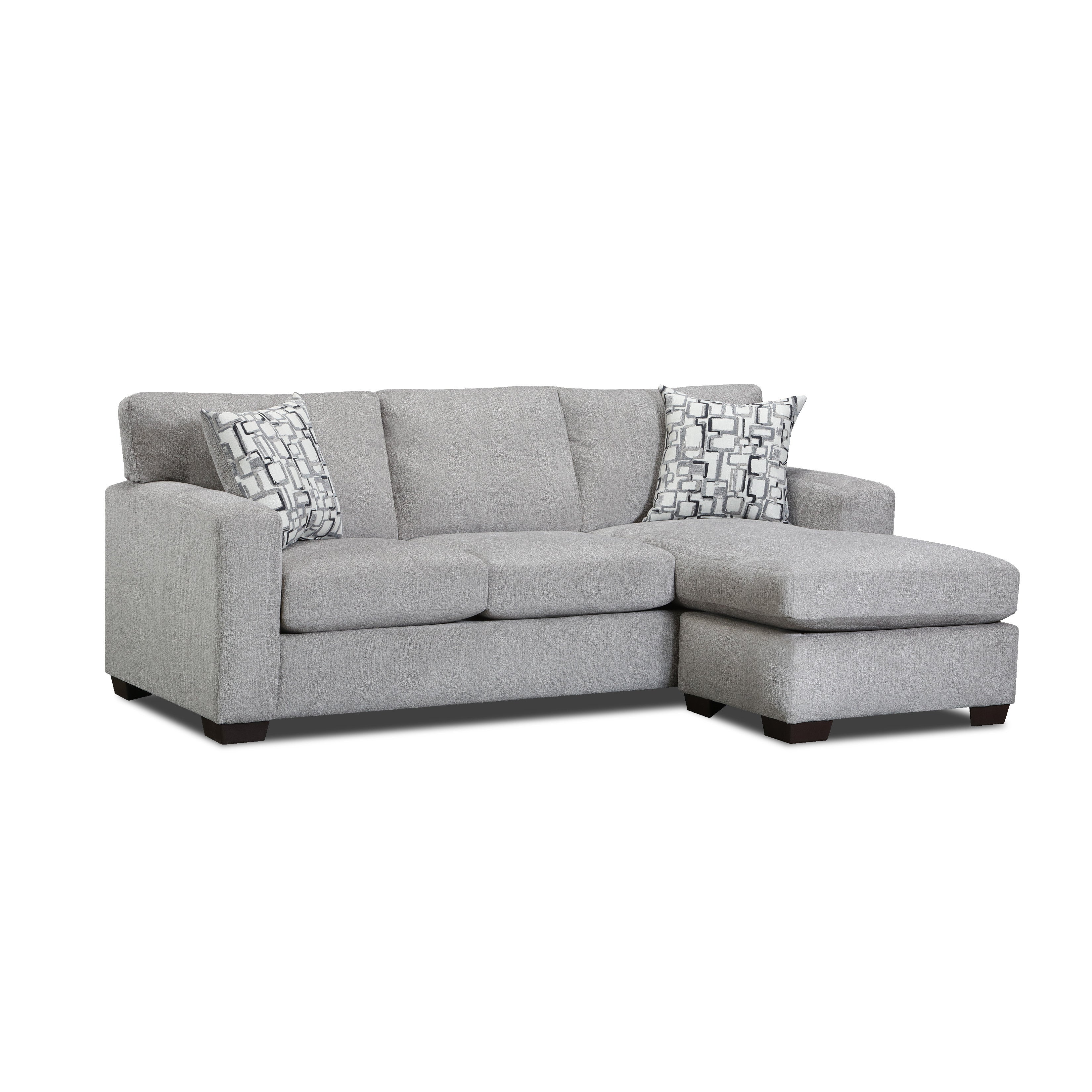 Light gray sectional sofa with chaise and two patterned pillows.
