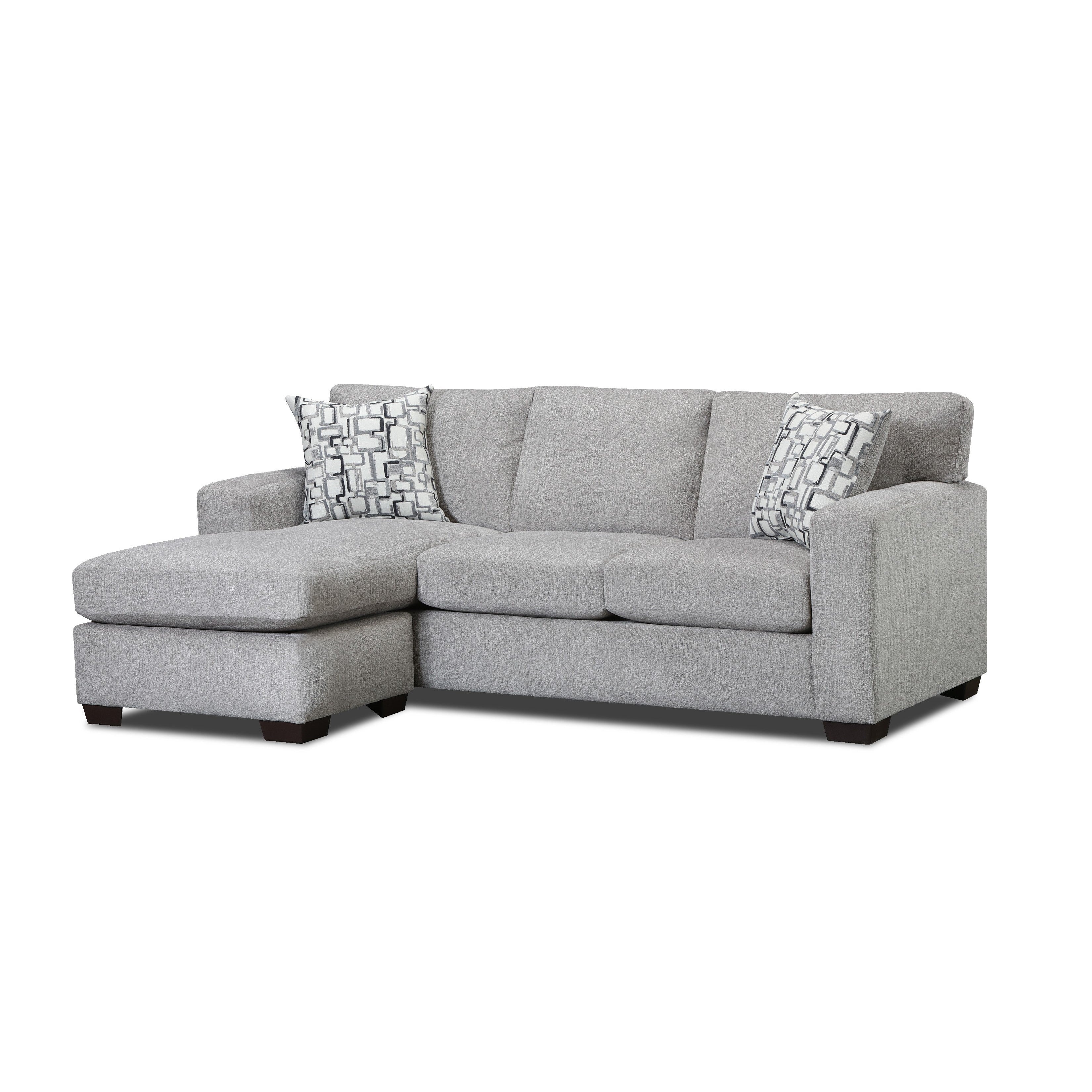 Light gray sectional sofa with chaise and two patterned accent pillows.