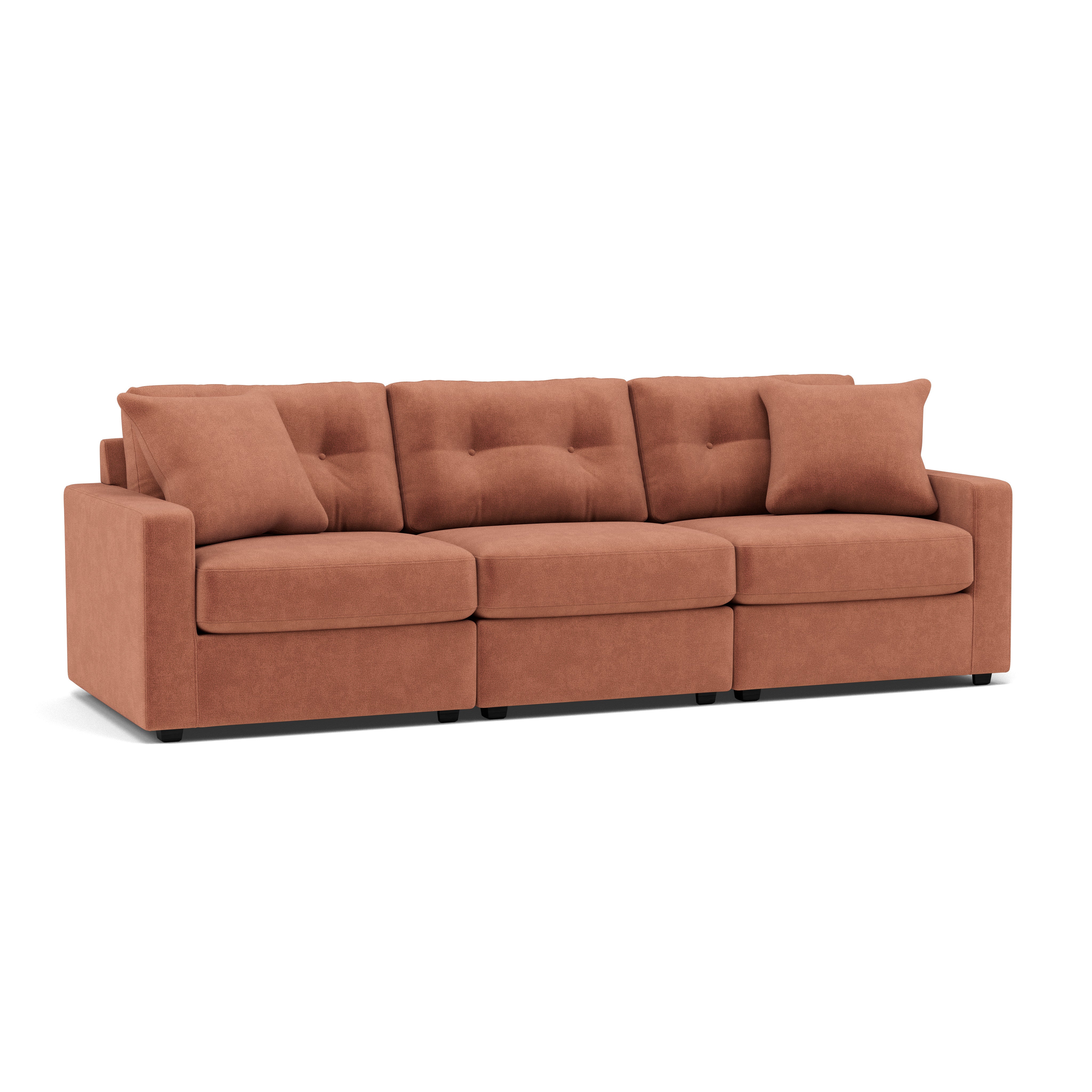 Rust-colored three-seat sofa with square arms and two back pillows on a white background.