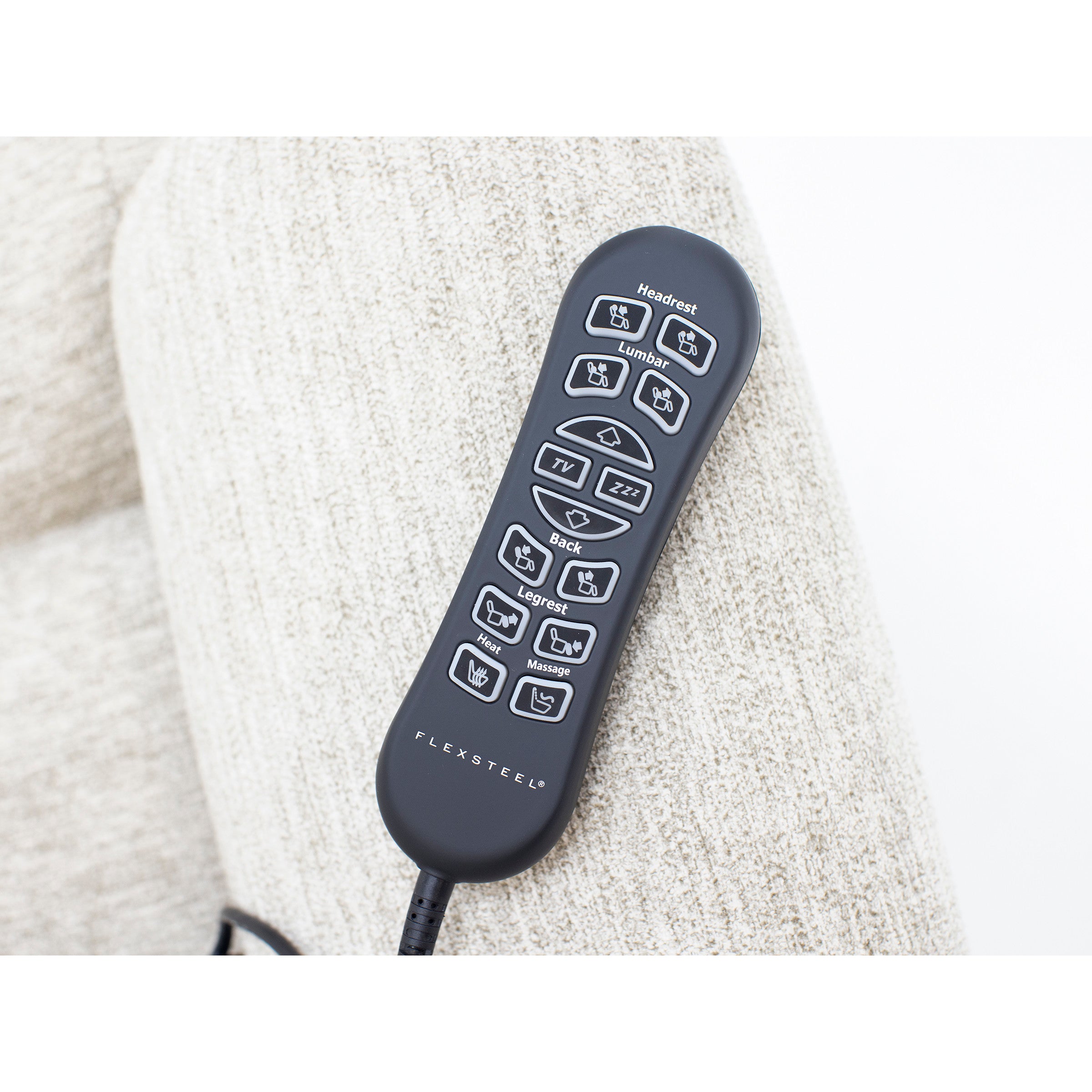 Flexsteel recliner remote control with labeled function buttons resting on a light fabric chair.