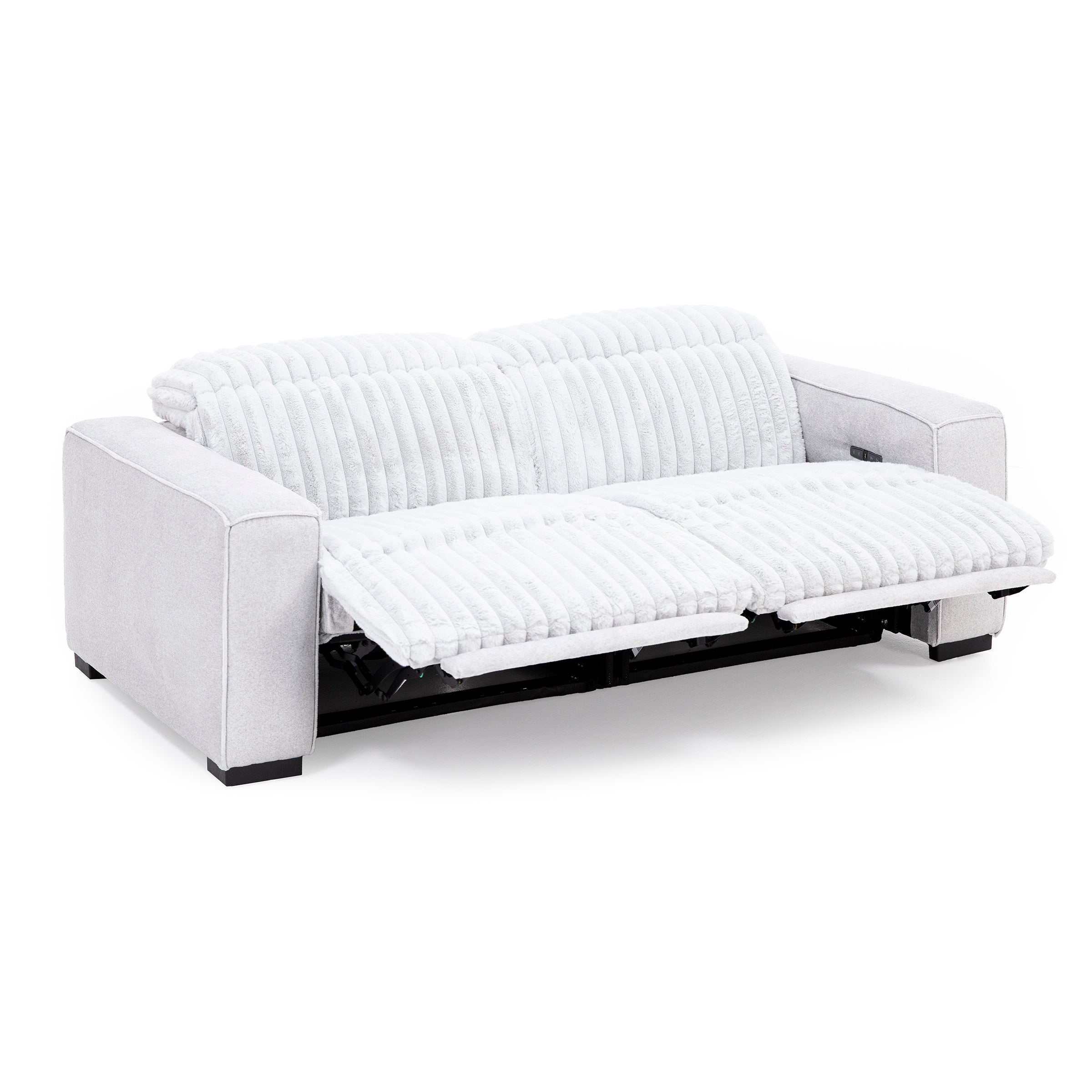 Light gray reclining sofa with plush, ribbed upholstery, shown fully extended.