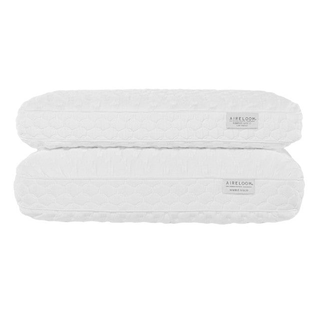 Two white Aireloom pillows stacked, featuring quilted covers and brand label.