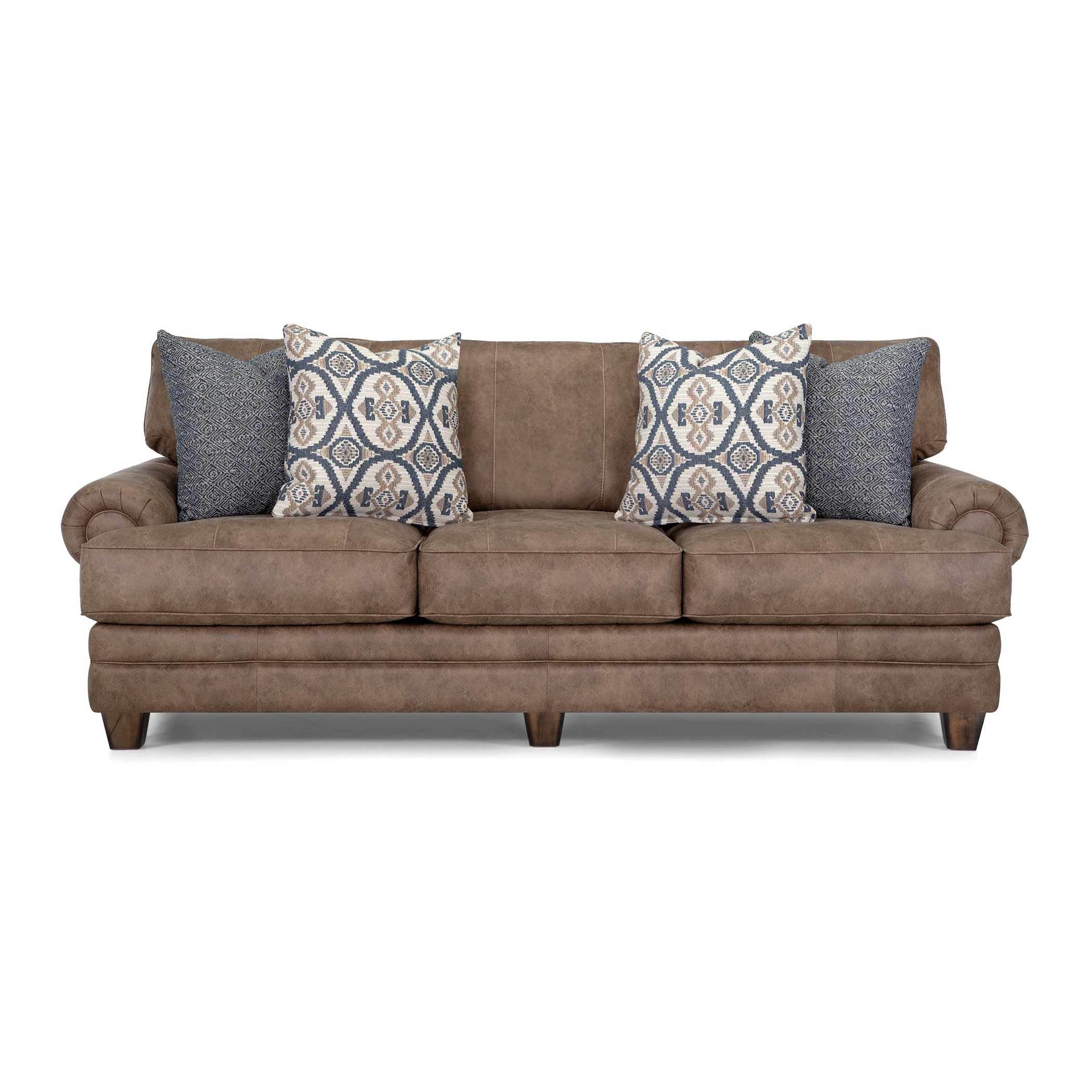 Brown sofa with three seat cushions and four patterned throw pillows, front view.