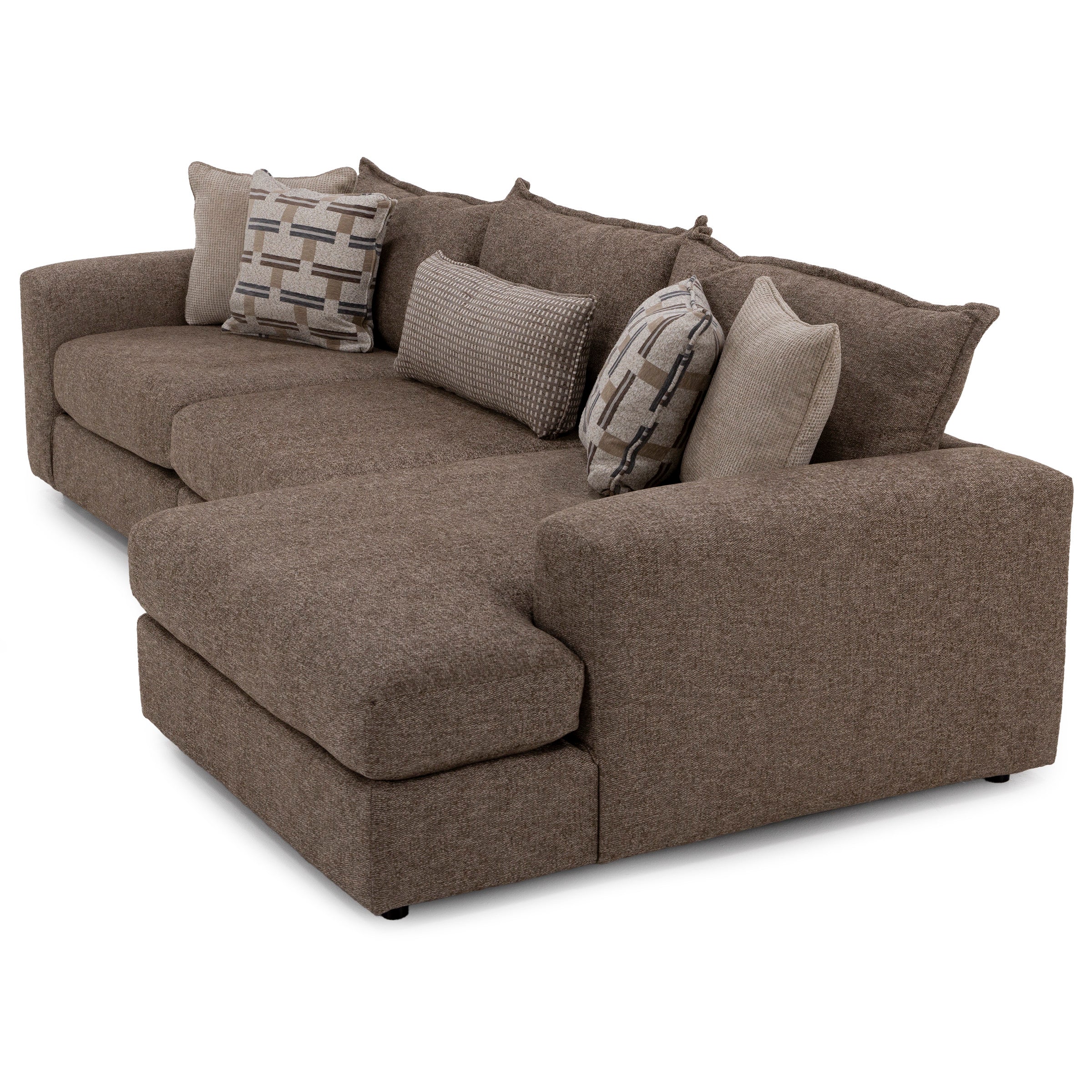Brown sectional sofa with assorted patterned and solid throw pillows.