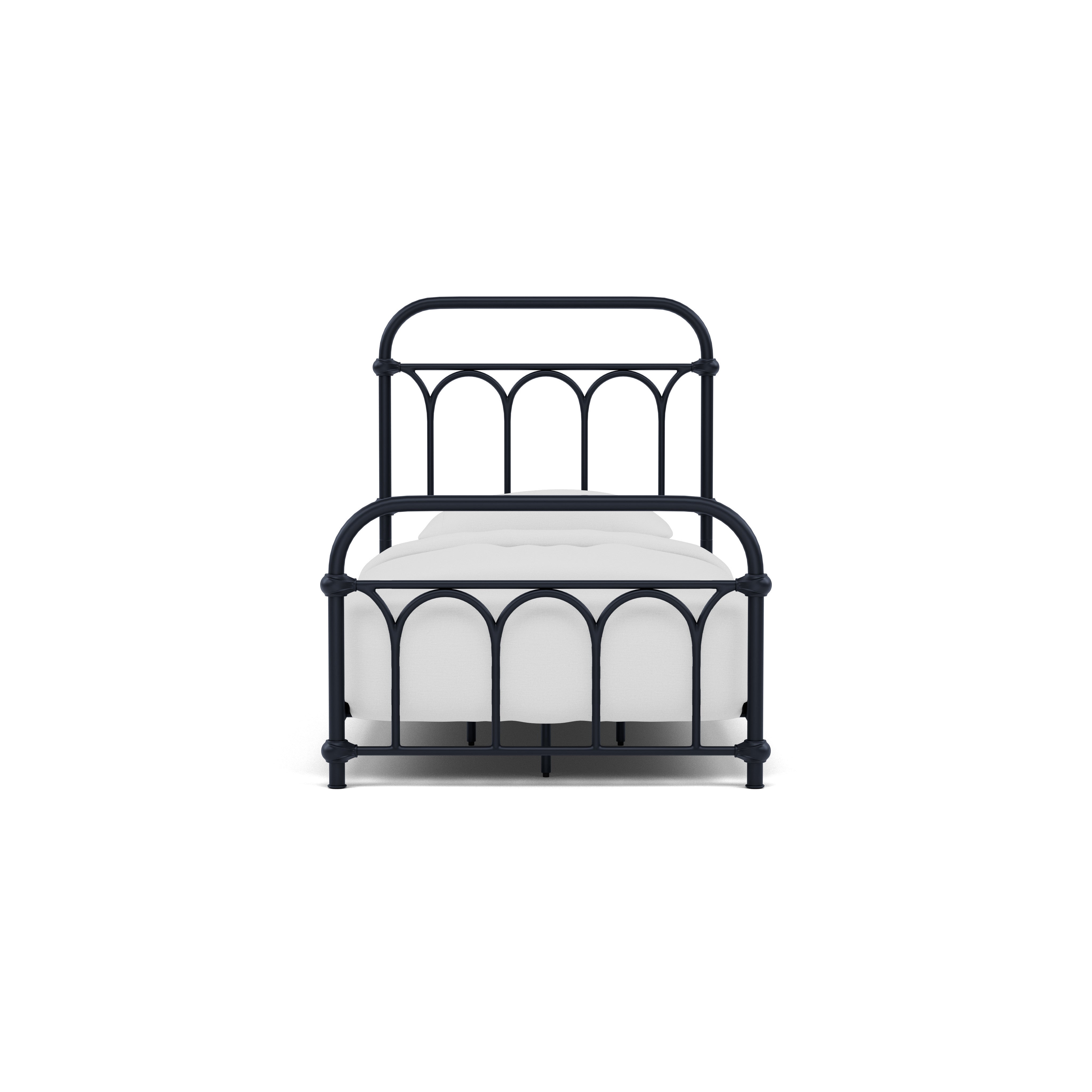 Black metal bed frame with white bedding, viewed from the front.