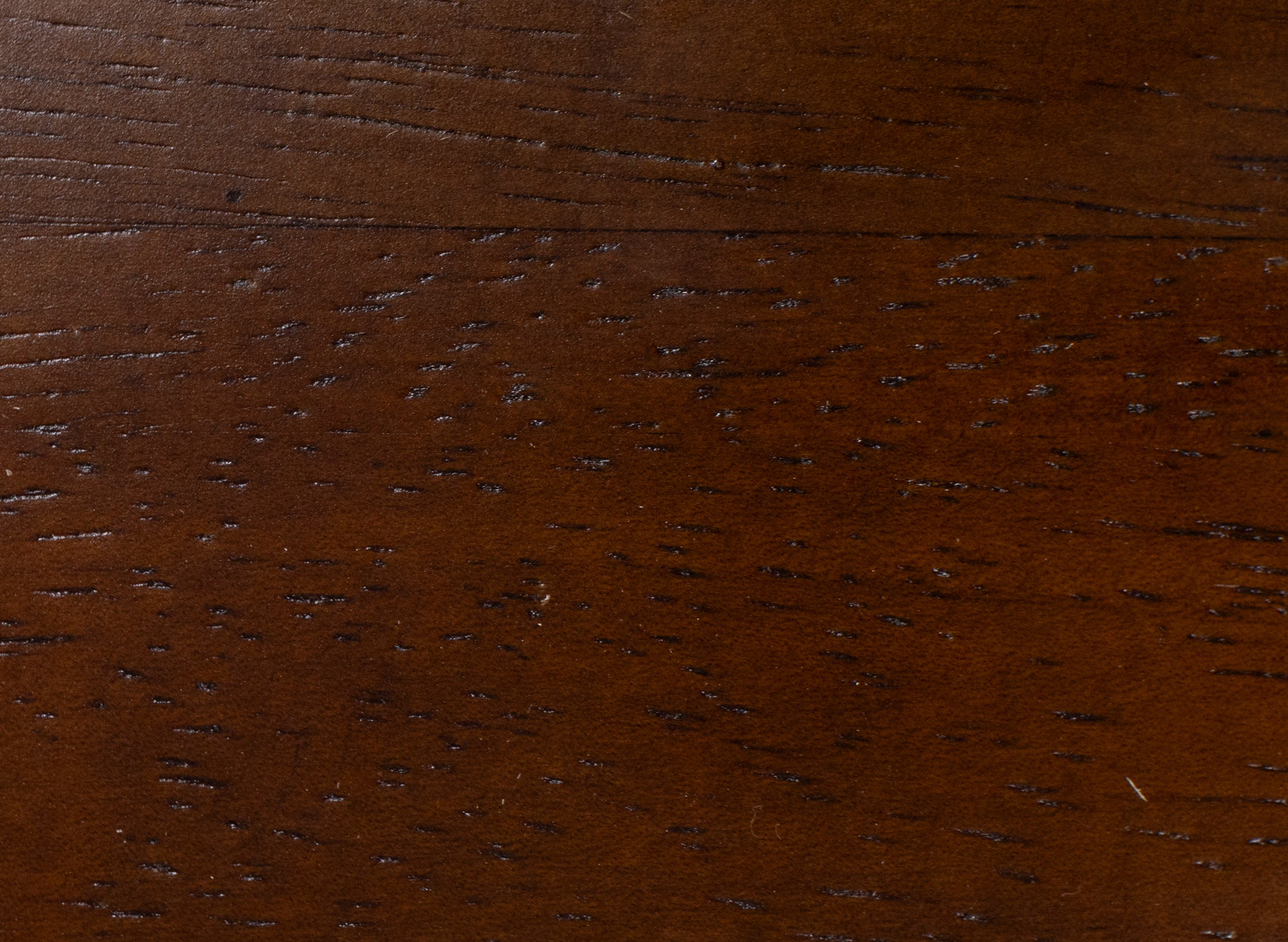 Close-up of dark brown wood grain texture.