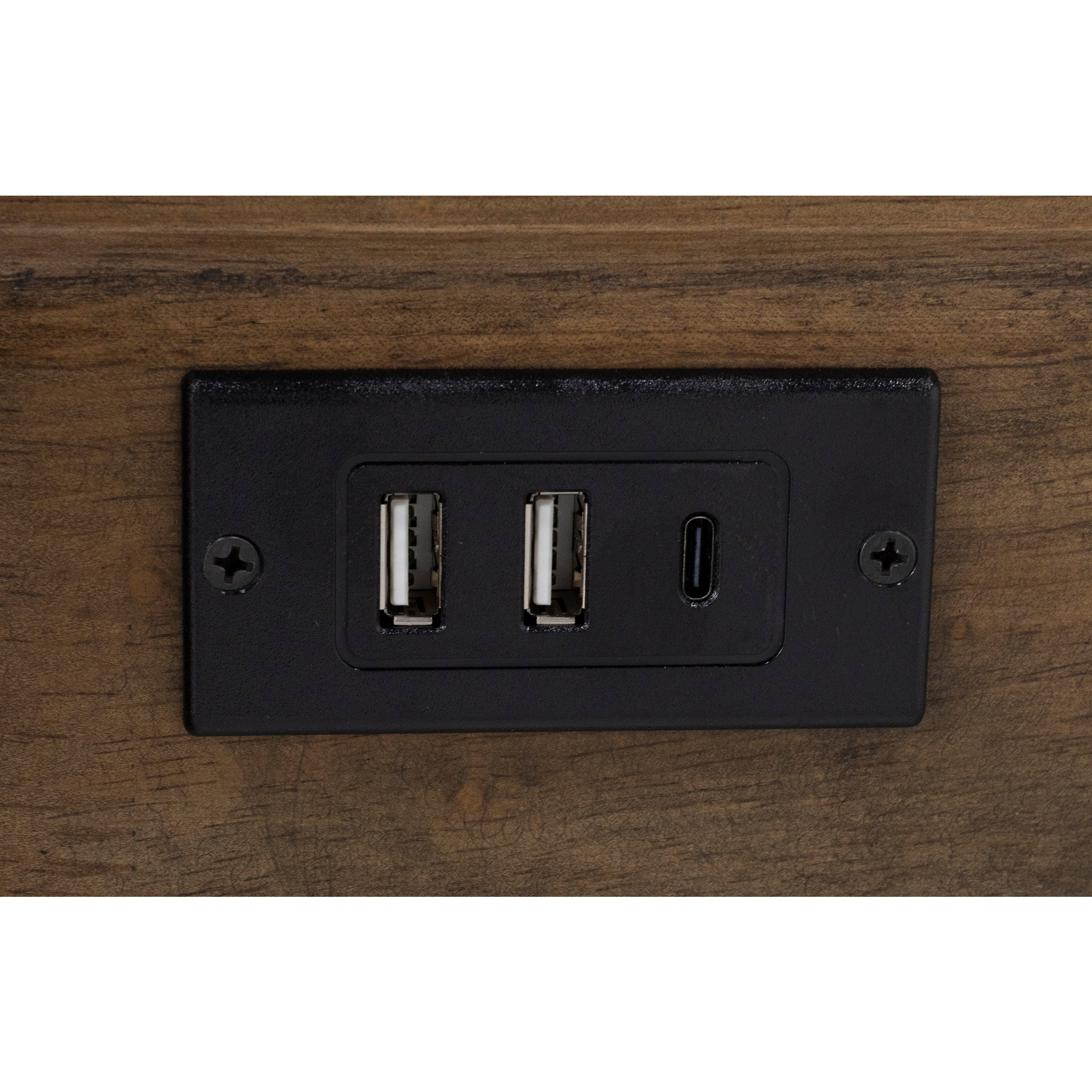 Close-up of a built-in panel with two USB-A and one USB-C charging port in a wood surface.