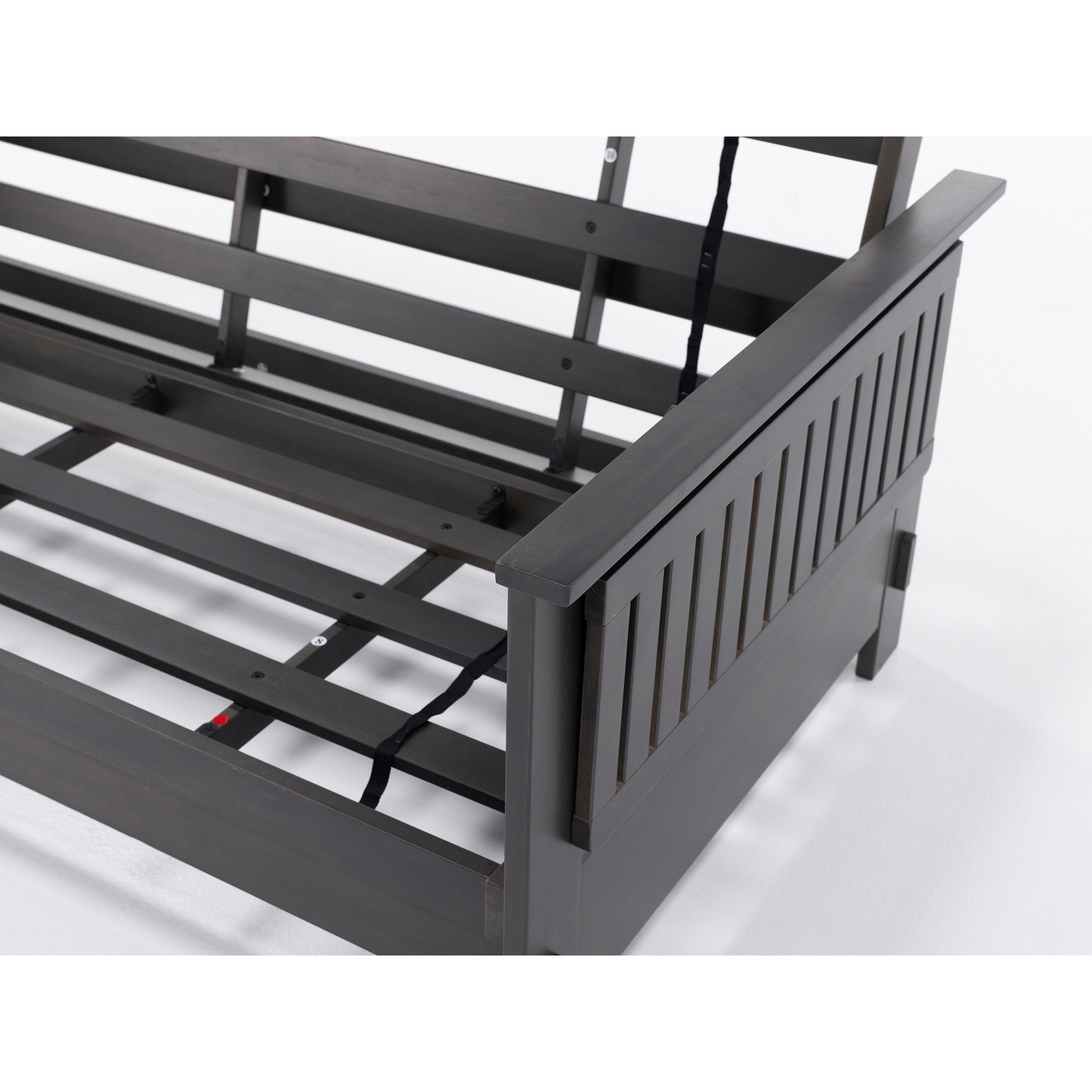 Close-up of a dark wood daybed frame showing slats and side panel.